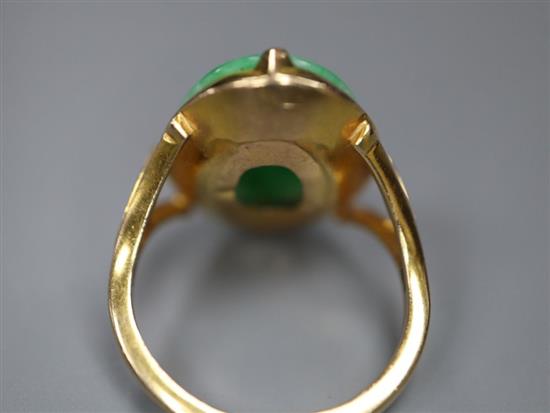 A yellow metal and oval cabochon jadeite set ring, size J, gross 4.6 grams,